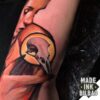 tatuaje bíceps cara chica cuervo cráneo