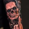 tatuaje antebrazo calavera mano guitarra